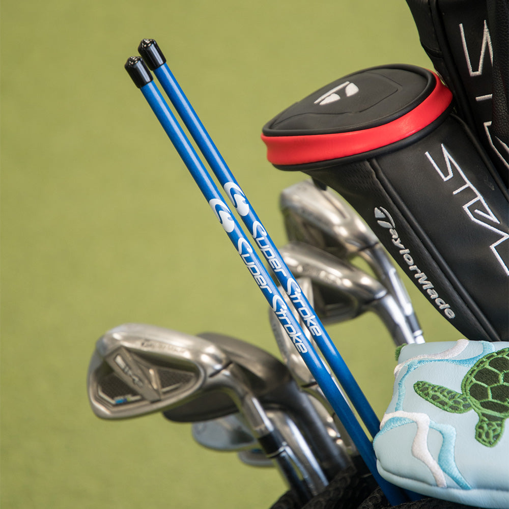 Blue golf alignment sticks in the golf bag